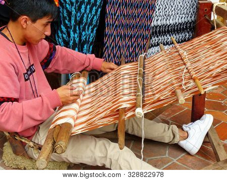 Cuenca, Ecuador - March 8, 2019: Ecuadorian Man Is Weaving Scarf Or Macana By Hand With Cotton Threa