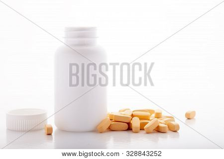 Closeup Scattered From White Pill Bottle Orange Oval Medicine Vitamins For Pregnancy, Pills, Drugs I