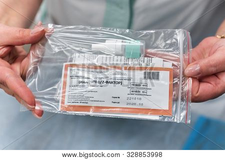 Hands Of Doctor Woman Holding Russian Test Kit For Express Detection Of Specific Antibodies To Human
