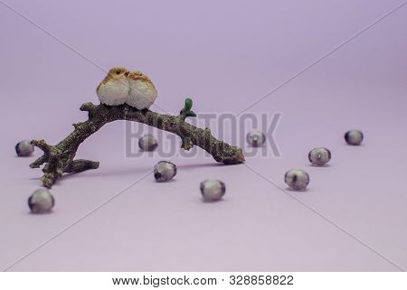 Two Figures Of Birds In Love Cuddle Sitting On A Branch Around A Bead Hearts On A Purple Background 