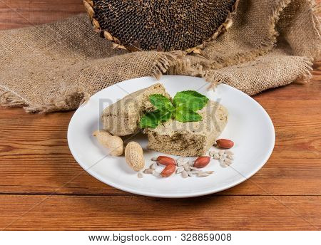 Crumbly Sunflower Halva With Peanuts Addition, Separately Mint Leaves, Sunflower Seeds, Peanuts On D