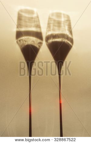 A Spectacular Long Shadow Falls From The Glass With Wine, Next To It Is The Shadow Of A Bottle Of Wi