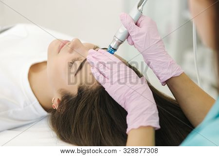 Close-up Of Woman Getting Facial Hydro Microdermabrasion Peeling Treatment. Female At Cosmetic Beaut