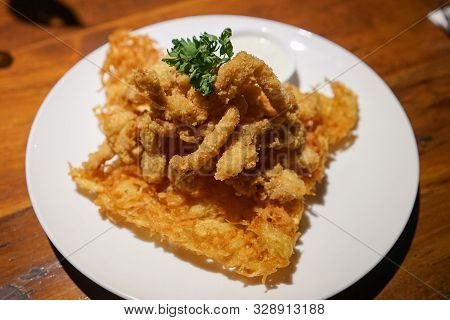 Fried Crispy Calamari Rings Breaded Squid Rings On A White Plate