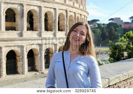 Young Female Tourist Standing Near Colosseum In Rome, Italy.