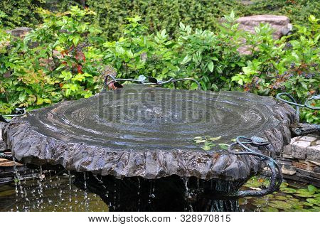 Easy Unobtrusive Fountain In The Park. A Bowl Of Water Fountain. Summer