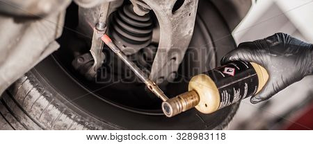 Car Master Mechanic Repairer Heating The Screws With Flamethrower Burner