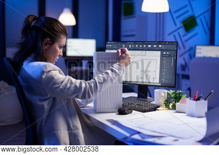 Woman Architect Analysing And Matching Blueprints For New Building Project Sitting At Desk. Graphic 