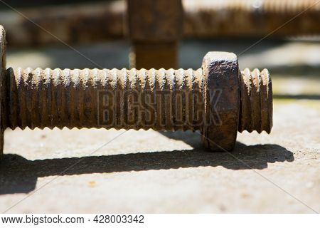 Old Rusty Bolt, Iron Rod With Screw Threads. Rusted Mechanical Components. Threaded Bolt And Nut. Di
