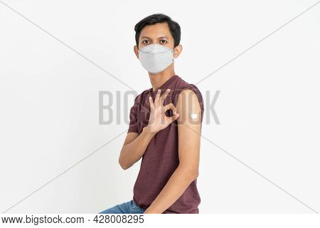 Asian Patient Getting Vaccinated Against Coronavirus By Doctor