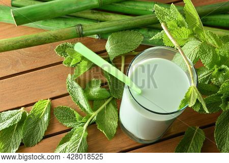 Milk Shake With Mint On Wooden Table And Mint Leaves. Elevataed View.