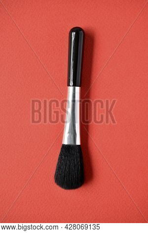 Brush For Cleaning Optics On A Red Background