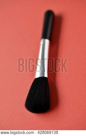 Brush For Cleaning Optics On A Red Background