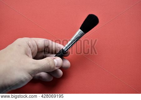 Brush For Cleaning Optics On A Red Background