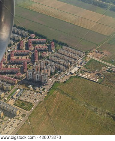 Land View Through The Airplane Window. Fields, Roads, Rivers From A Bird's Eye View. Porthole. Look
