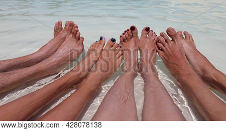 Eight Feet Of A Family Of Four In The Middle Of The Water In Complete Relaxation