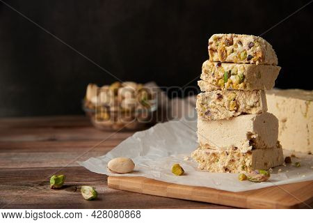 Organic Halva With Pistachios On A Wooden Surface. Traditional Middle Eastern Sweets. Jewish, turkis