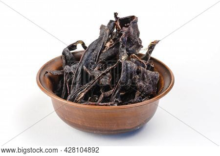 Dried Dog Treats In A Brown Clay Bowl On A White Background. Thin Slices Of Dehydrated Beef Heart. T