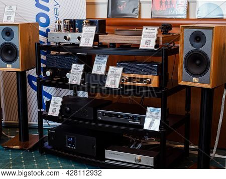 Moscow, Russia - May 23, 2021: Cayin Tube Stereo Amplifiers, Arcam Network Player, Old School Booksh