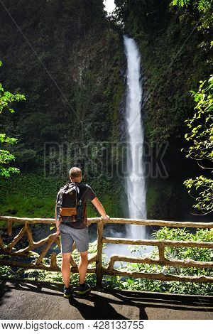 Tourist Looking At The La Fortuna Waterfall In Costa Rica