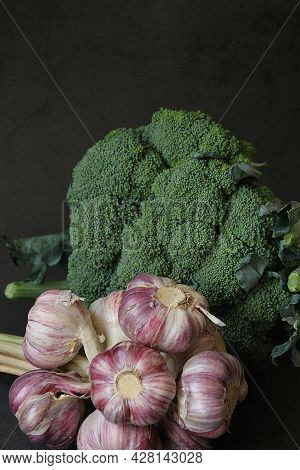 A Bunch Of Garlic, A Bouquet Of Garlic, Fresh Garlic And Green Broccoli, A Large Head Of Broccoli