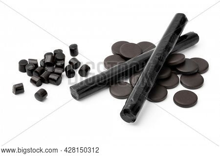 Heap of black Bay Leaf Licorice in different shape isolated on white background 