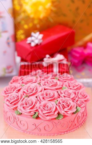 Docorated On Cake And Gift Boxes In Background