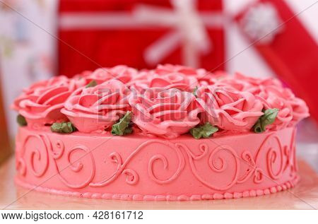 Docorated On Cake And Gift Boxes In Background