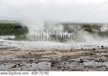Tourists Visiting Strokkur Geyser In Iceland