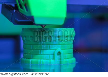 Print Head Of 3d Printer Machine Printing Green Plastic Model At Modern Scifi Technology Exhibition,