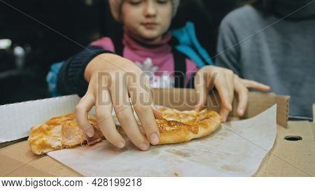 Mother And Daughter Eat Pizza Cheese Four. Close Up Of Young Woman Eating Pizza And Chewing In Outdo