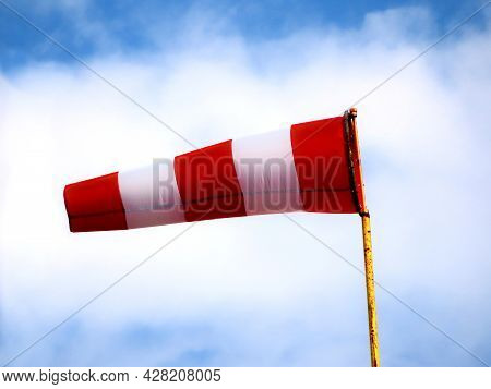 Windsock Indicator Of Wind On Runway Airport. Wind Cone Indicating Wind Direction And Force. Horizon