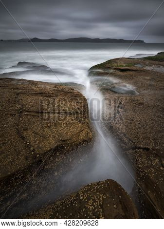 Water Flowing Into A Body Of Water