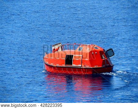 Offshore Life Boat Or Survival Craft At Muster Station Of Oil And Gas Drilling Rig.