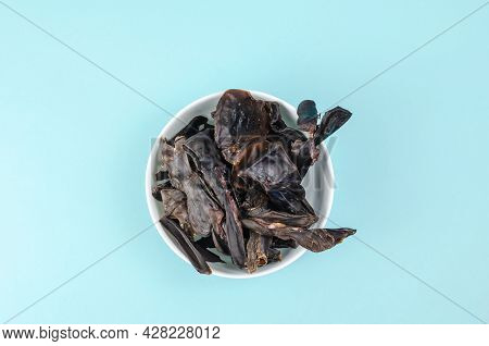 Training Treats For Pets On Blue Background. Natural Air Dried Dog Treats In A White Ceramic Bowl. Y