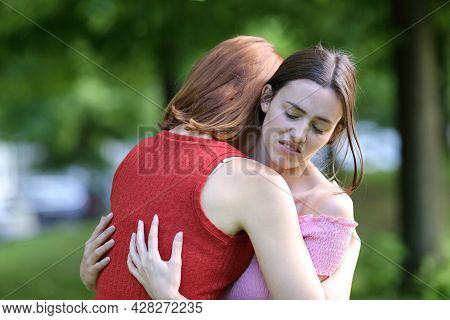 Hypocrite Woman Meeting And Hugging Her Friend In A Park
