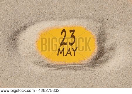 May23. 23th Day Of The Month, Calendar Date. Hole In Sand. Yellow Background Is Visible Through Hole
