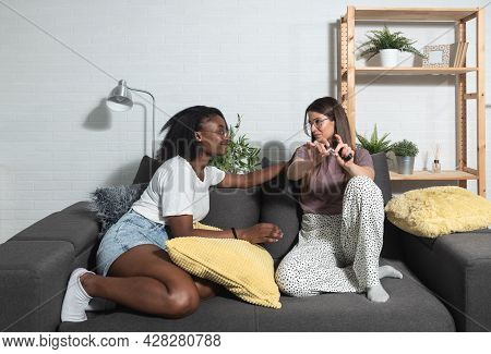 Young Black And White Lesbian Homosexual Couple Sitting At Home Make A Deal About Quitting Smoking C