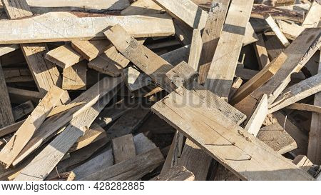 Remains Of Planks With Nails After The Installation Of Concrete Formwork. Recycling Of Lumber. Backg