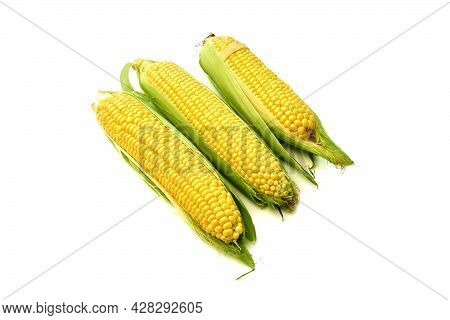 Young Appetizing Corn On The Cob And Peeled On A White Background.