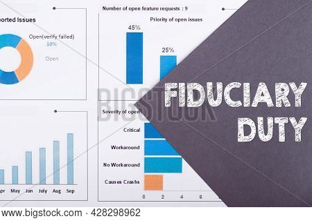 The Word Fiduciary Duty Is Written On A Gray Background With Diagrams And Graphs.