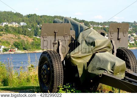 Old Cannon In The Field, Photo In The Background, A Cannon From The Second World War