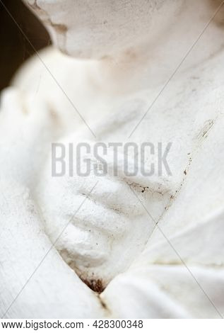 Hands On The Chest. Old Sculpture Of The Young Girl. Close-up.