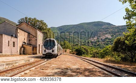 Palasca, Corsica, France - 28th July 2021: A Train Passes Through The Derelict Station At Palasca In