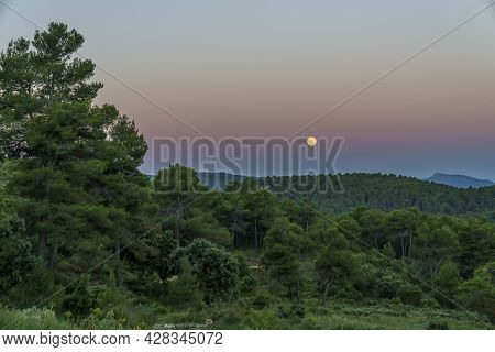 Sunrise In The Sierra De Mariola Natural Park With A Full Moon.