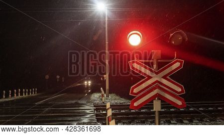 Train Crossing Gates Closed At Night. Train Grade Crossing With Blinking Or Flashing Lights While Tr