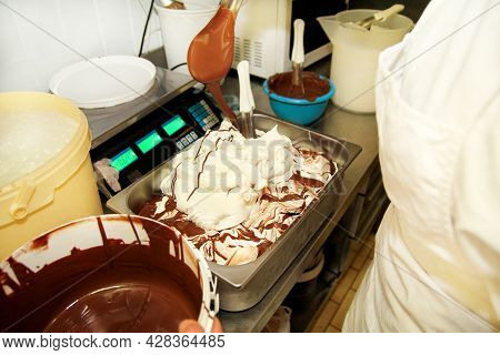 Woman Working At Ice Cream Factory Is Decorations Of Creamy Vanilla Ice Cream With Chocolate Dressin