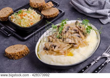 Mashed Potatoes With Butter, Fried Mushrooms With Onions And Salad Of Fresh Vegetables On A Gray Cem