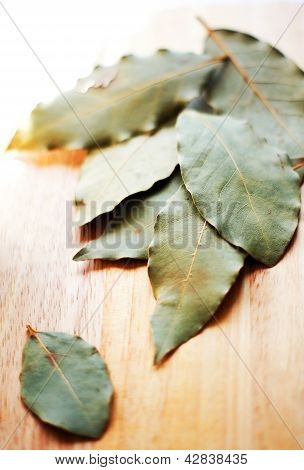 Closeup Of Bay Leaves On The Wooden Desk