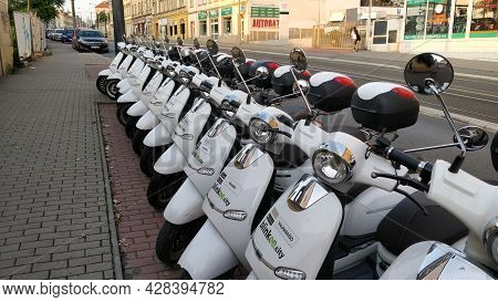 Prague, Czech Republic - June 23, 2021: Sharing Motorbike Company Fleet Line Up By The Road Waiting 